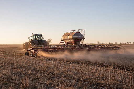 Air seeder tractor working in a broadacre Australian paddock during seeding season